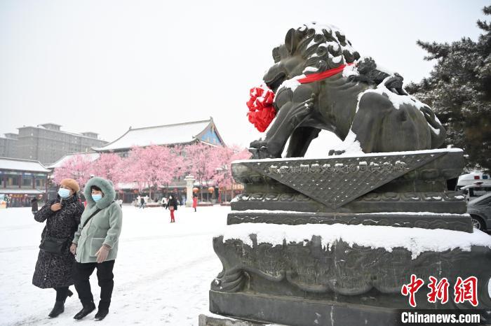 2月13日，民眾在呼和浩特市大召廣場雪中漫步?！⑽娜A 攝