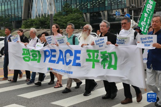 7月22日，在韓國首爾，人們手舉標語參與反戰(zhàn)游行。新華社發(fā)（楊暢 攝）