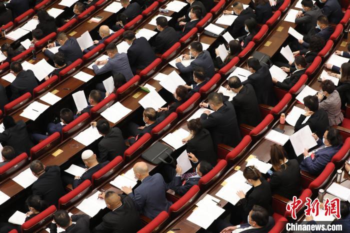圖為會議現(xiàn)場，參會代表正在聽取政府工作報告?！∑钤鲚?攝